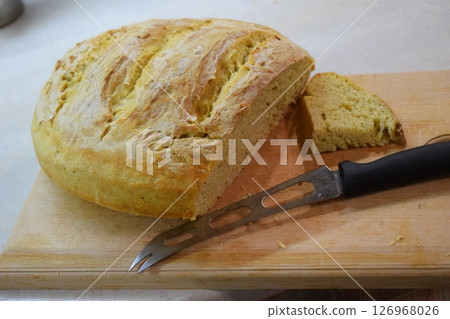 Freshly Baked Bread with Knife on Cutting Board 126968026