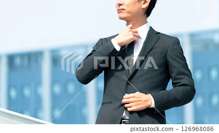 Male businessman who arranges tie 126968086