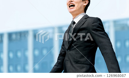 Male businessman walking in an office district 126968087