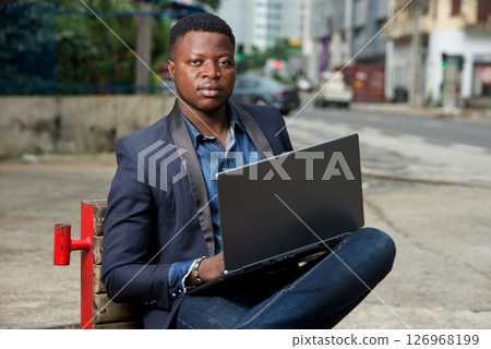 portrait of young man with laptop. 126968199