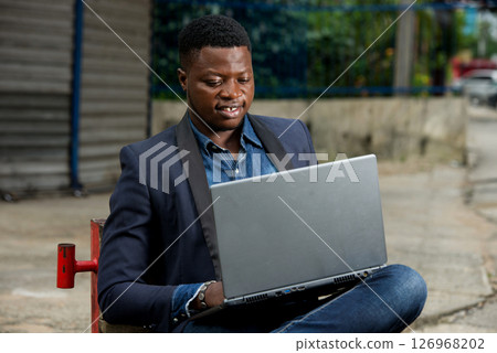 portrait of young man with laptop. portrait of young man with laptop. 126968202