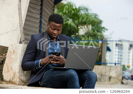 portrait of young man with laptop. 126968204