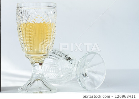 Crystal glass filled with white wine, elegant design, in a bright environment, close-up, selective focus, no people, 126968411