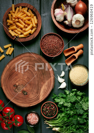 food concept, wooden chopping board, on a wooden table, with ingredients, spices and herbs, top view, vertical, no people, food concept, wooden chopping board, on a wooden table, with ingredients, spices and herbs, top view, vertical, no people, 126968419