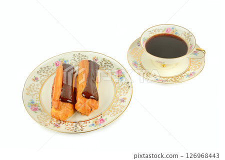 Coffee in a porcelain cup and Chocolate cake isolated on a white. Coffee in a porcelain cup and Chocolate cake isolated on a white. 126968443