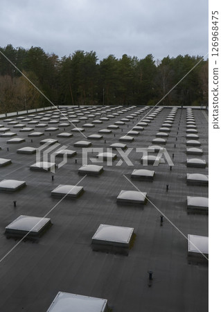 Modern roof with natural light. Skylights. Energy efficiency. Transparent panels Modern roof with natural light. Skylights. Energy efficiency. Transparent panels 126968475