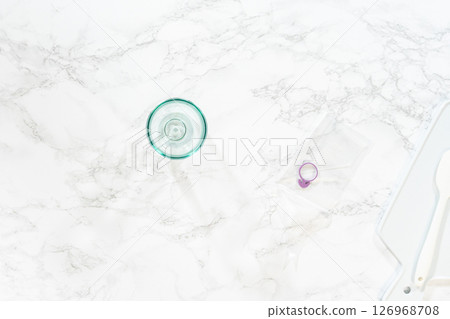 Flat lay. Piping bag is expertly filled with luscious caramel to be delicately infused into each of these decadent chocolate cupcakes. 126968708