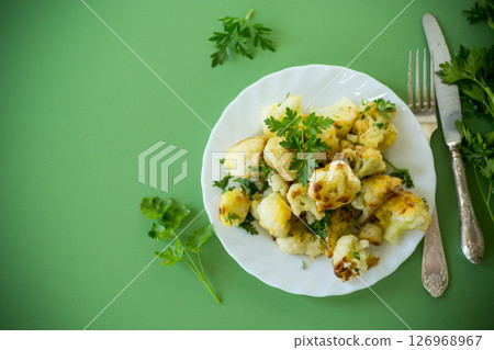 Top view of crispy cauliflower with parsley on a green background Top view of crispy cauliflower with parsley on a green background 126968967