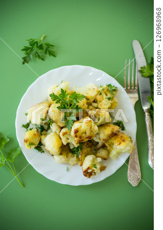 Appetizing fried cauliflower on a green background 126968968