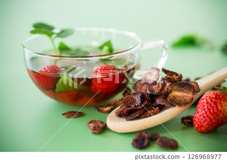 Aromatic herbal drink with berries on a green background 126968977