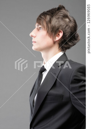 young businessman black suit casual tie on gray background 126969085
