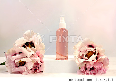 Spa salon advertising card. Wellness composition with lilac water and fresh mountain peony flowers, natural self-care and healthy lifestyle concept, abstract composition with flowers. Spa salon advertising card. Wellness composition with lilac water and fresh mountain peony flowers, natural self-care and healthy lifestyle concept, abstract composition with flowers. 126969101