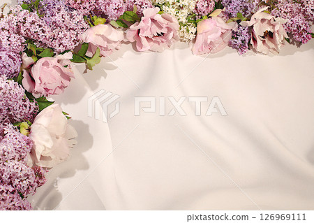 Beautiful spring blooming branches of lilac and mountain peony on sunny background. Abstract flower arrangement and banner for screen, Still life with place for text, Floral holiday card Beautiful spring blooming branches of lilac and mountain peony on sunny background. Abstract flower arrangement and banner for screen, Still life with place for text, Floral holiday card 126969111