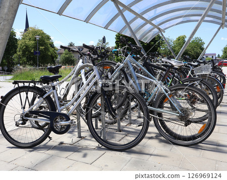 Group of Bicycles Parked Under a Modern Canopy on a Sunny Day 126969124