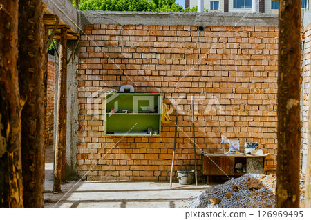 house under constraction with modern brick walls and holes for doors and windows. High quality photo 126969495