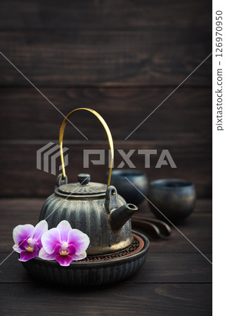 Traditional asian tea ceremony arrangement: ceramic teapot, cups and bamboo chaban Traditional asian tea ceremony arrangement: ceramic teapot, cups and bamboo chaban 126970950