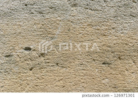 Close up of a rough stone wall displaying unique textures and colors 126971301