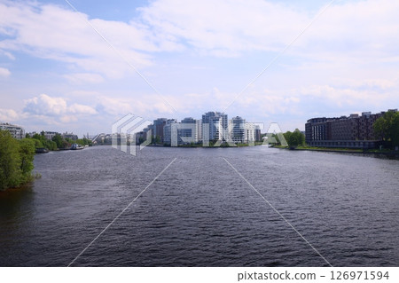 A modern urban landscape beautifully situated by the calming water, offering serene vistas 126971594