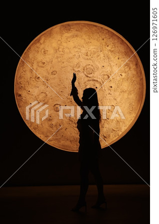 A stunning silhouette against a lunarinspired design a captivating, charming night scene A stunning silhouette against a lunarinspired design a captivating, charming night scene 126971605