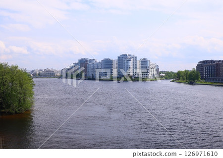 Experience the modern riverfront buildings situated gracefully near the tranquil waters edge 126971610