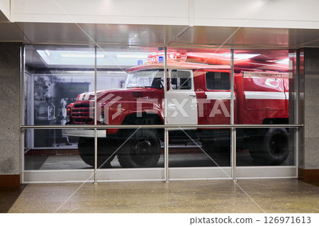 A Stunning Display Showcasing a Vintage Fire Truck Set Within a Modern Urban Environment A Stunning Display Showcasing a Vintage Fire Truck Set Within a Modern Urban Environment 126971613