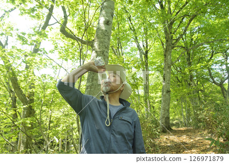 Elderly people bathing in the forest stay hydrated to prevent heatstroke Elderly people bathing in the forest stay hydrated to prevent heatstroke 126971879