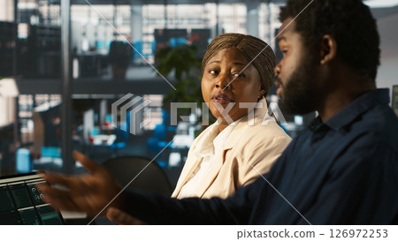 Angry manager in office berating worker for not hitting revenue key performance targets. Upset management executive fighting with employee at work scolding him for low output, camera A Angry manager in office berating worker for not hitting revenue key performance targets. Upset management executive fighting with employee at work scolding him for low output, camera A 126972253