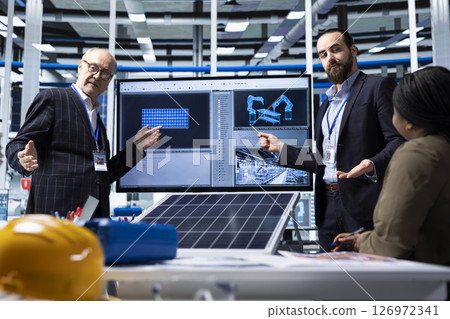 Factory businessmen doing sales presentation for shareholders, showing solar panel solutions. Industrial plant managers showcase product innovations in sustainable energy sector in front of investors Factory businessmen doing sales presentation for shareholders, showing solar panel solutions. Industrial plant managers showcase product innovations in sustainable energy sector in front of investors 126972341