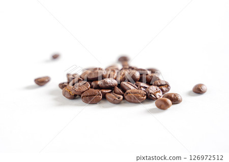 Coffee beans on white background. Pile of coffee beans. Close up image. 126972512