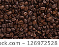 Roasted coffee beans background. Top view of dark brown coffee beans. Close up image. 126972528