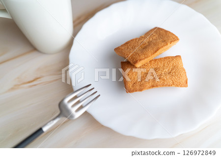 Freshly baked financiers with a fork① 126972849