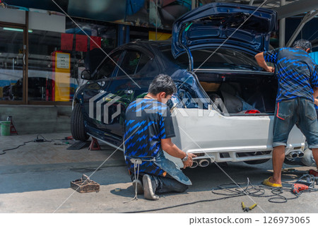Checking car body work fiber bumper at car garage 126973065