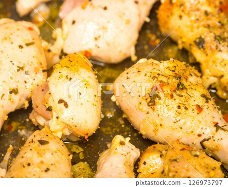 AI generated top view of perfectly grilled chicken steak pieces on charcoal grill, juicy and tender with light smoke. Seasoned with salt and black pepper, garnished with rosemary sprigs. 126973797