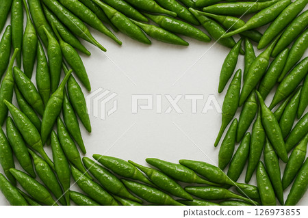 Fresh green chili peppers pile top view 126973855