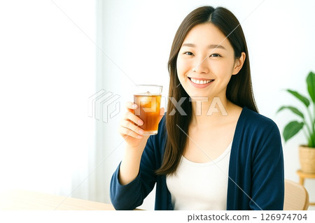 Summer morning lifestyle of a woman relaxing by the window and enjoying barley tea 126974704