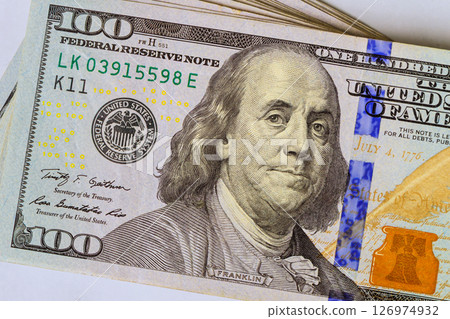American hundred dollar bill highlighting Benjamin Franklin elements of currency design. 126974932