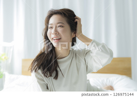 Young woman waking up in the bedroom 126975144