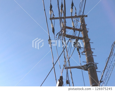 A huge steel tower on the outskirts of a residential area A huge steel tower on the outskirts of a residential area 126975245