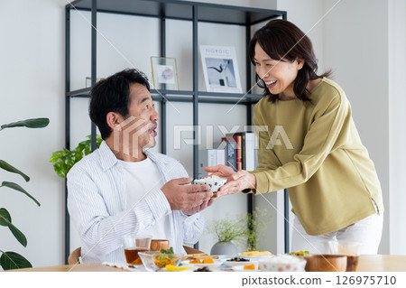 Middle-aged couple eating 126975710