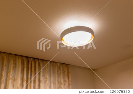 A circular light installed on the ceiling of the room A circular light installed on the ceiling of the room 126976520
