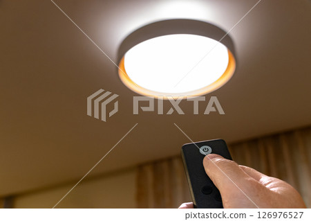 Turn on the lights in the room with a remote control Turn on the lights in the room with a remote control 126976527