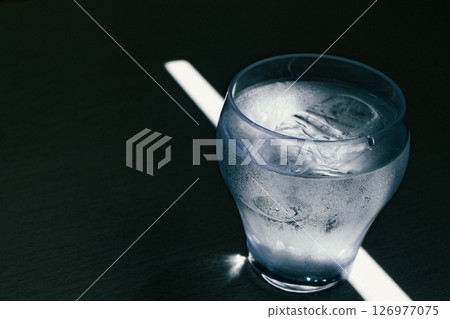 Glass bathed in a ray of light 126977075
