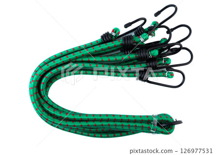 Set of green bungee cords with black metal hooks, coiled together and secured for transport. Elastic tie down straps on white background. Set of green bungee cords with black metal hooks, coiled together and secured for transport. Elastic tie down straps on white background. 126977531