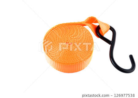 Bright orange cargo strap with a metal hook and ratchet, isolated on white background. New equipment used for securing loads or for transport. Bright orange cargo strap with a metal hook and ratchet, isolated on white background. New equipment used for securing loads or for transport. 126977538