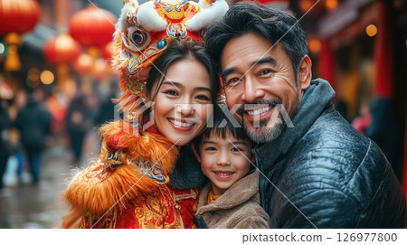 A joyful family celebrates Chinese New Year with radiant smiles, traditional lion dance, and colorful lanterns, cherishing unity, love, and festive traditions in a vibrant street setting. 126977800
