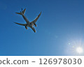 A passenger plane heading towards the bright sun at Haneda Airport, seen from Jonanjima Seaside Park on a clear winter day 126978030