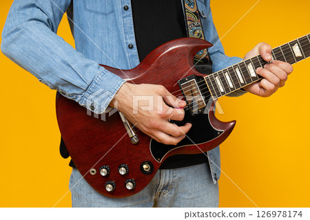 A man plays a beautiful guitar close-up 126978174