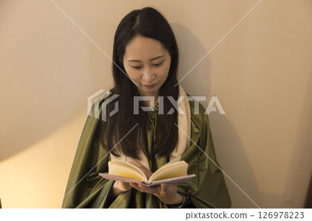 Image of a woman reading while taking a mugwort steam bath 126978223