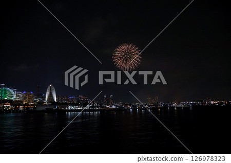 A vibrant city skyline at night near Yokohama Port with lights and boats 126978323