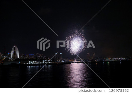 A vibrant city skyline at night near Yokohama Port with lights and boats 126978362